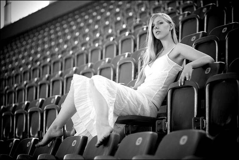 Woman in White Dress — Dramatic, Photograph, Stadium Seats