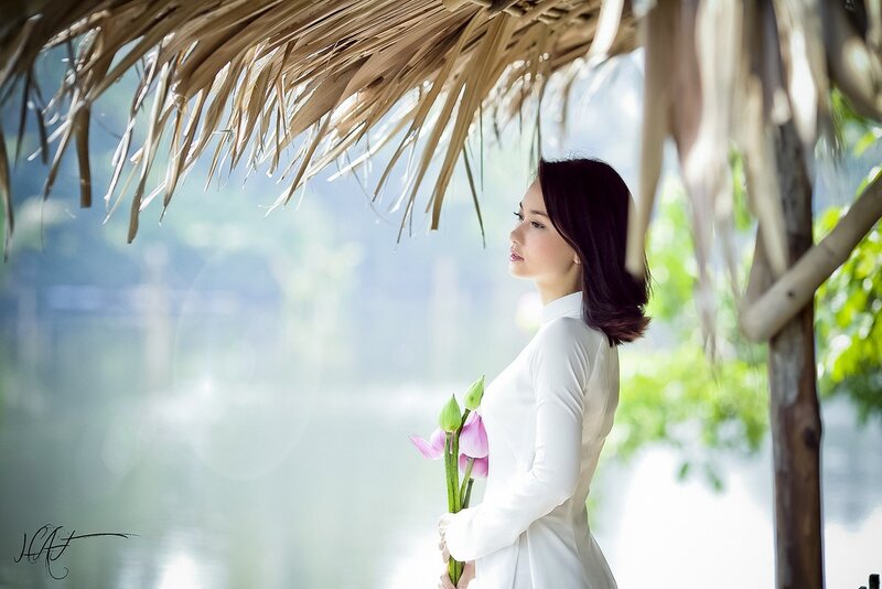 Woman in white dress holding flowers