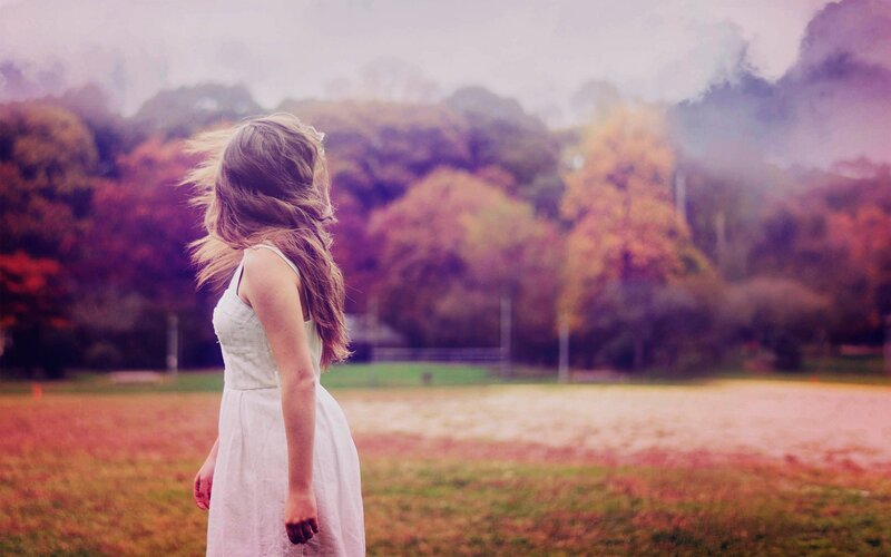Woman in white dress in autumn field