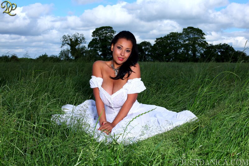 Woman in white dress in field