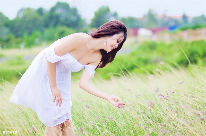 Woman in white dress in field