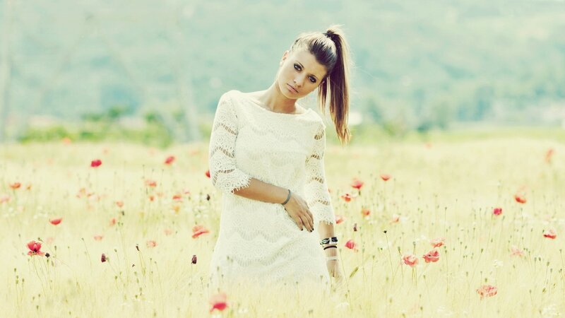 Woman in white dress in field