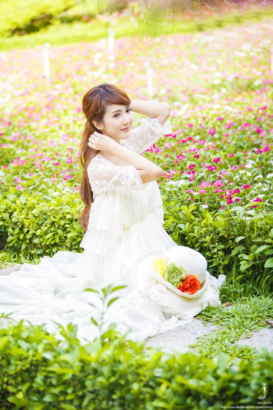 Woman in white dress in flower field
