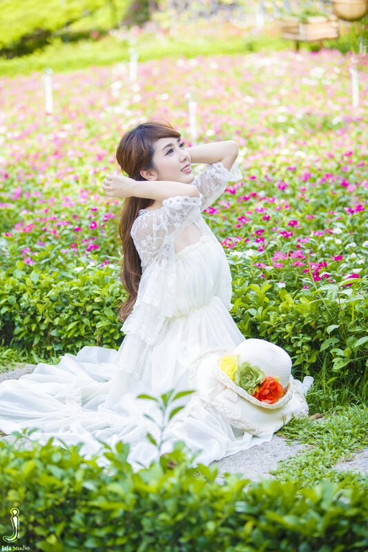 Woman in white dress in flower field