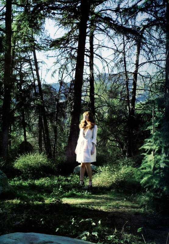 Woman in white dress in forest