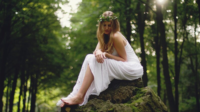 Woman in white dress in forest