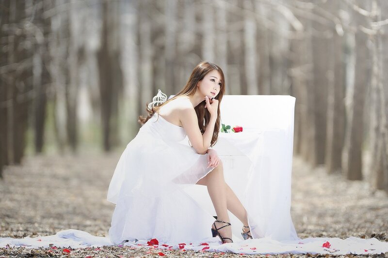 Woman in white dress in forest