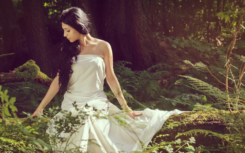 Woman in white dress in forest