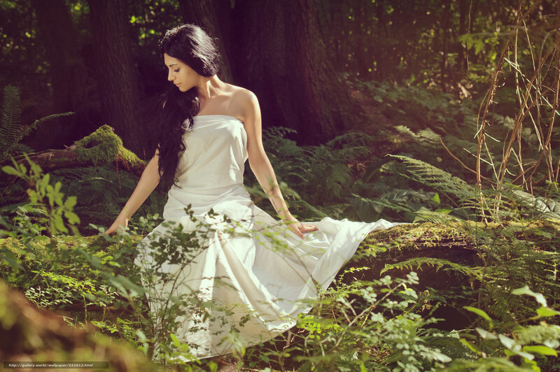 Woman in white dress in forest