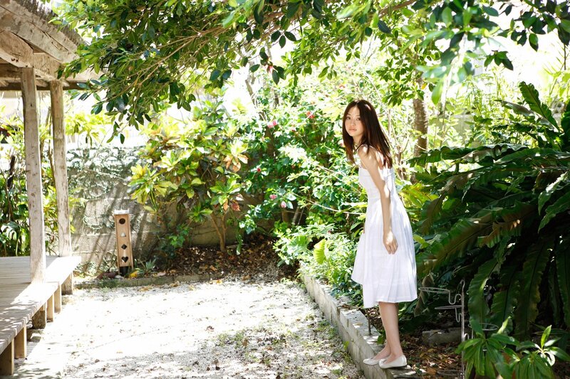 Woman in white dress in garden
