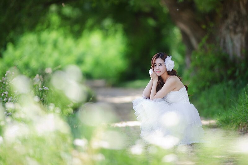 Woman in white dress in garden