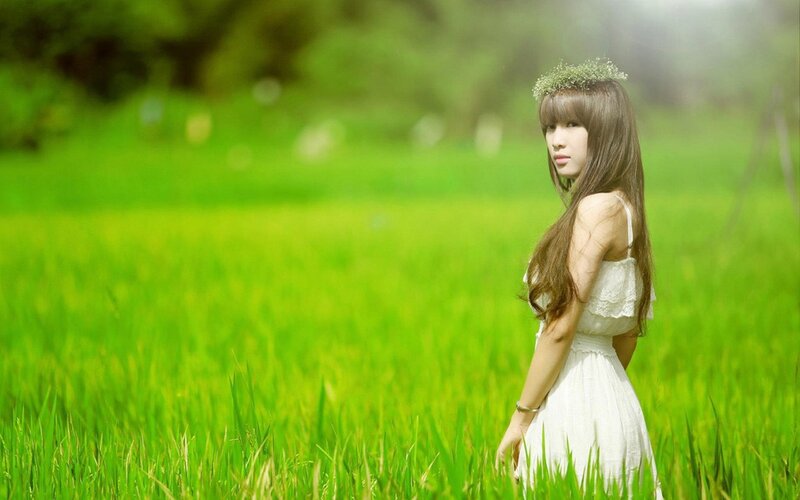 woman in white dress in green field