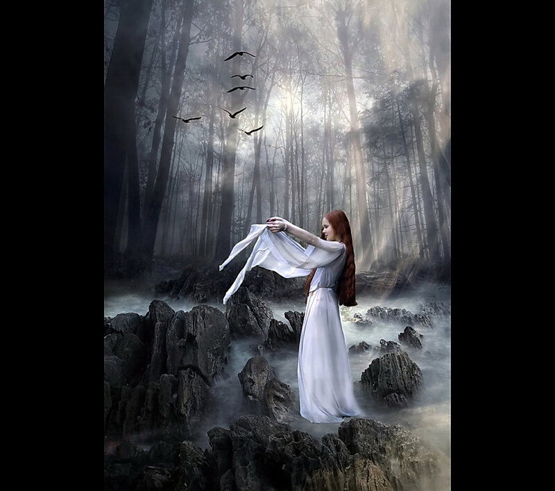 Woman in white dress in misty forest
