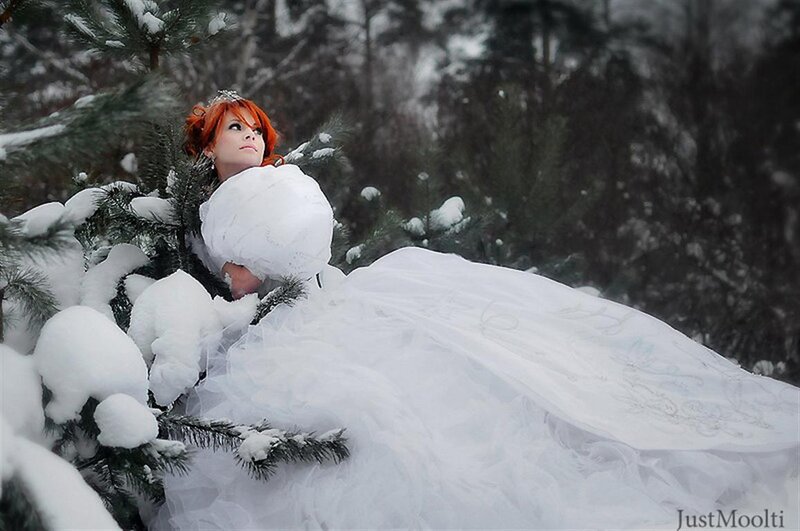 Woman in white dress in snowy forest