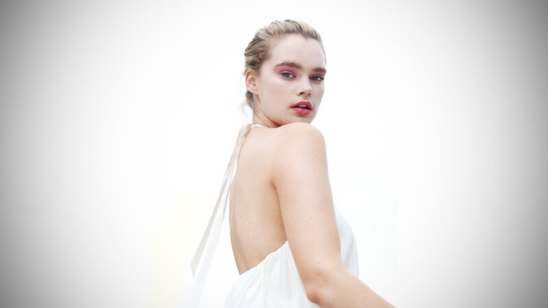 woman in white dress looking back