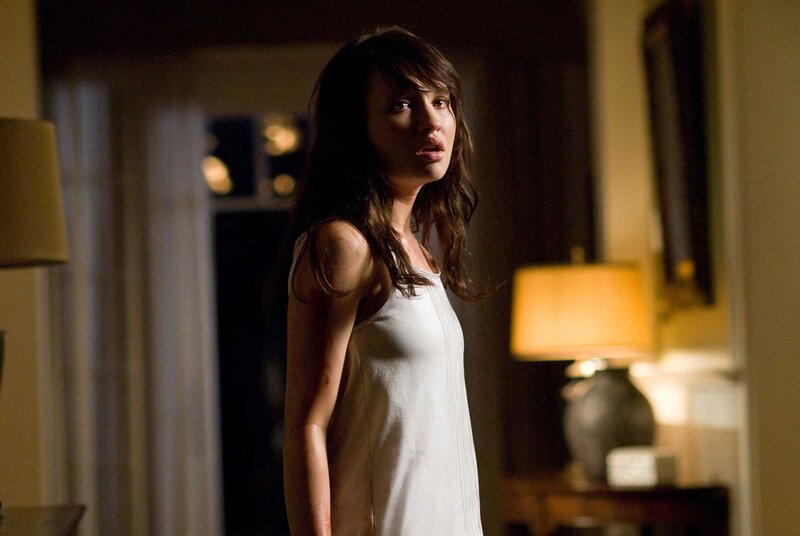woman in white dress looking scared
