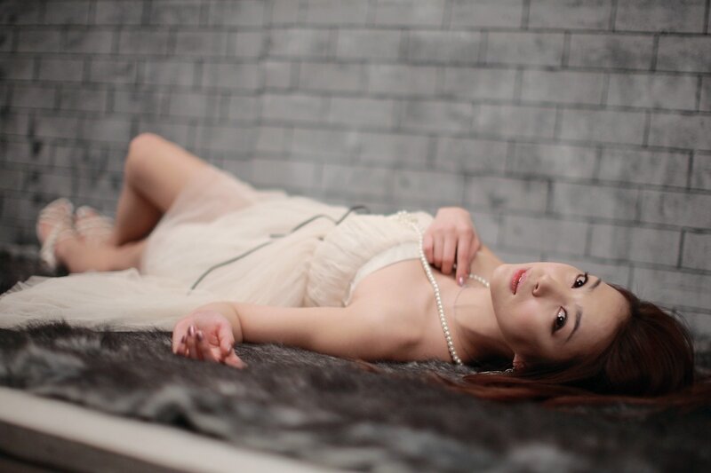 woman in white dress lying down