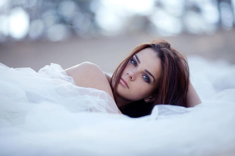 woman in white dress lying down