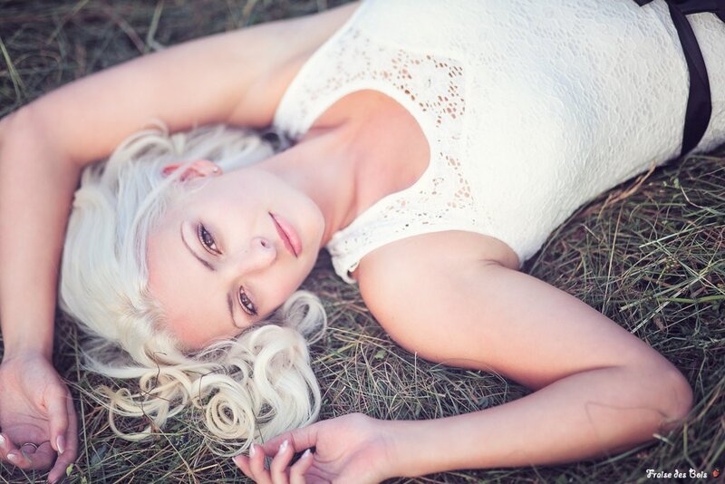 woman in white dress lying on grass
