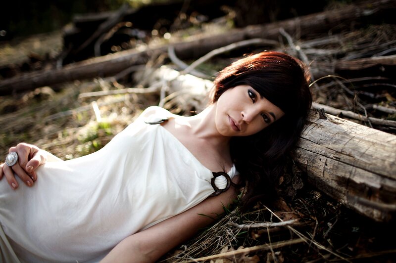 woman in white dress lying on log