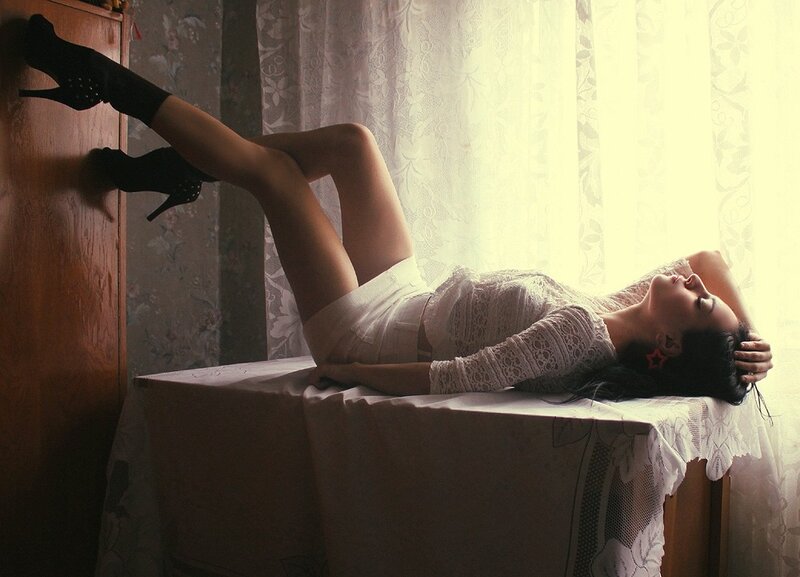 woman in white dress lying on table