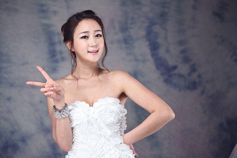 Woman in white dress making peace sign