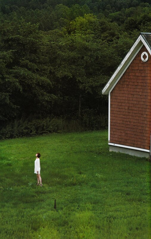 Woman in white dress on a green field