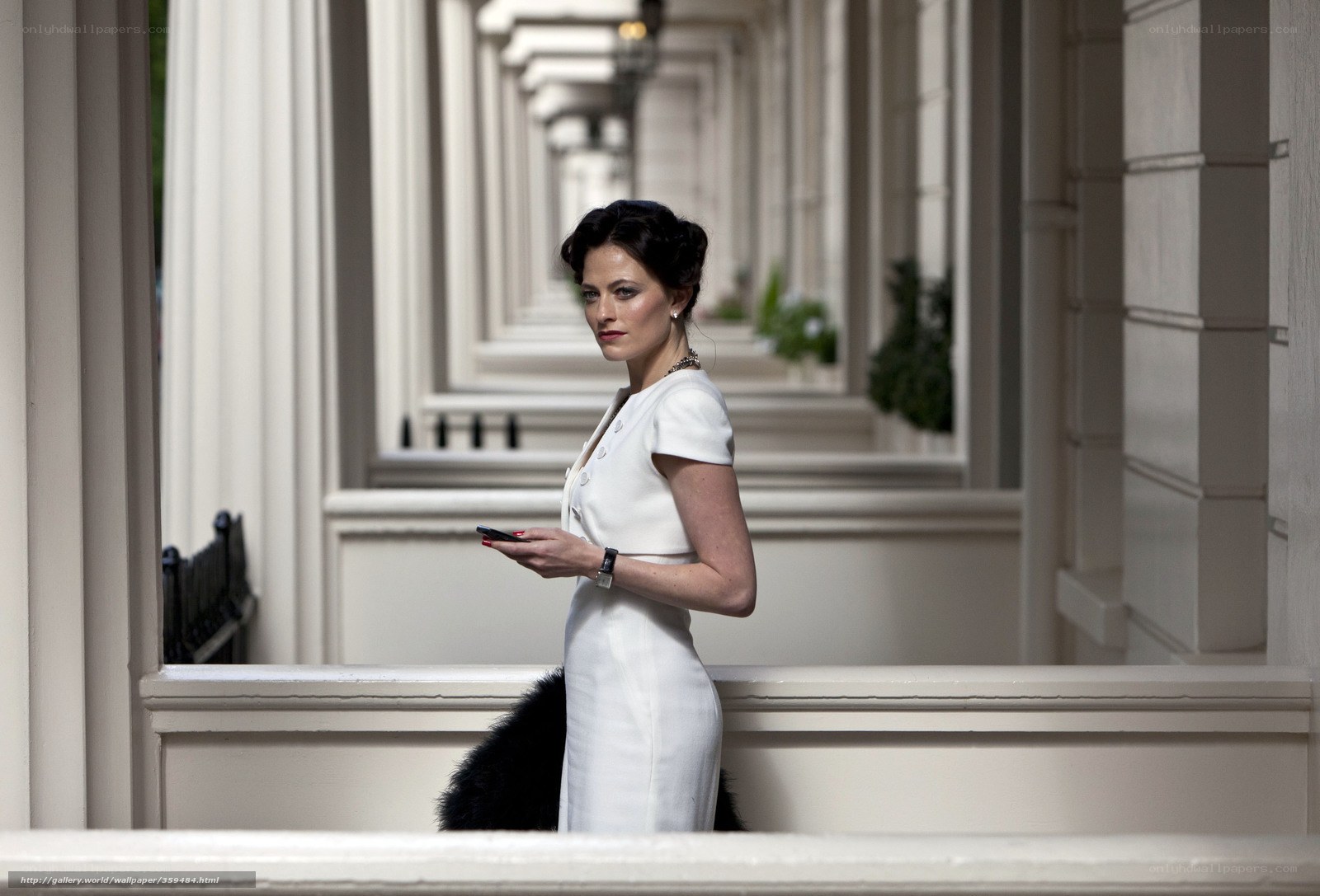 Woman in white dress on balcony