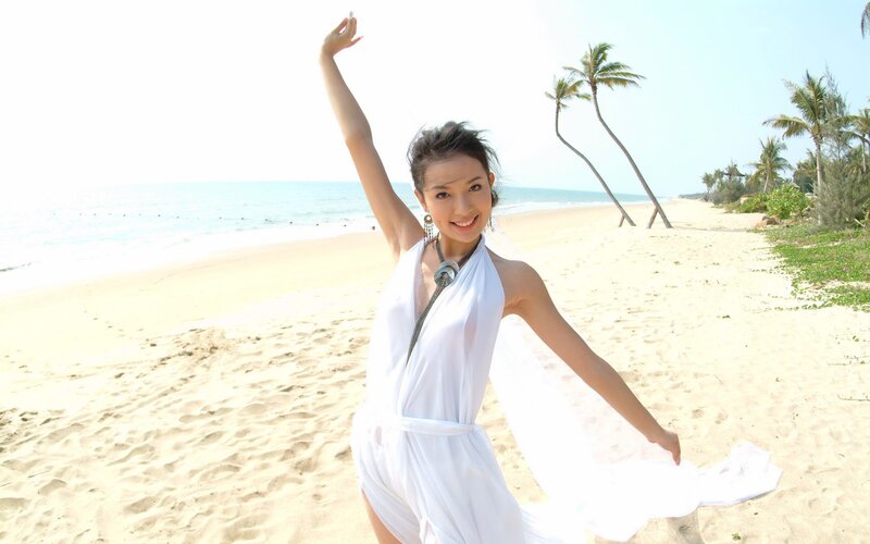 Woman in white dress on beach