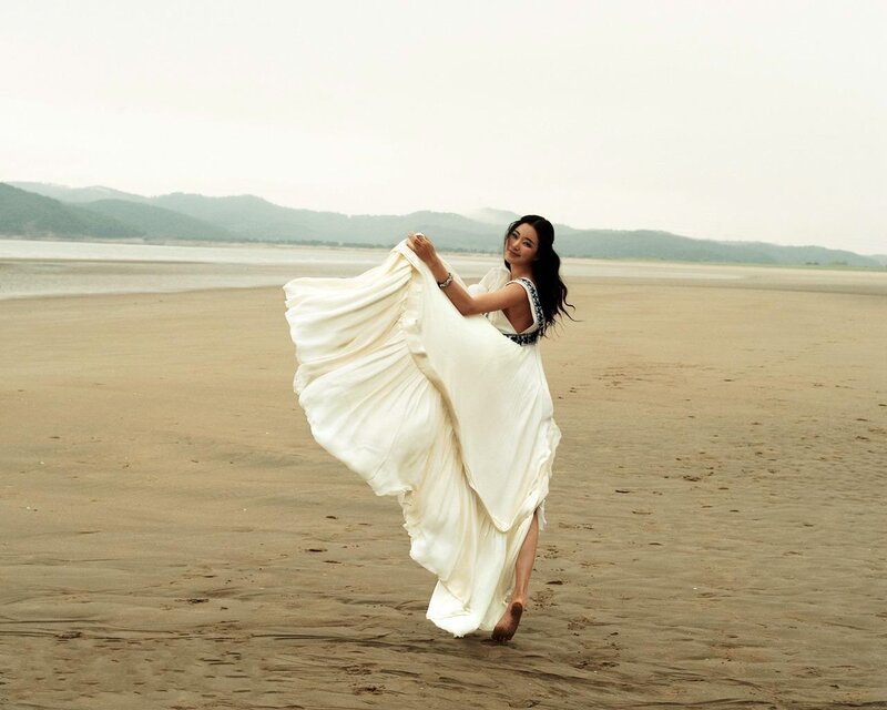 Woman in white dress on beach