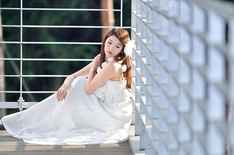 Woman in white dress on bridge
