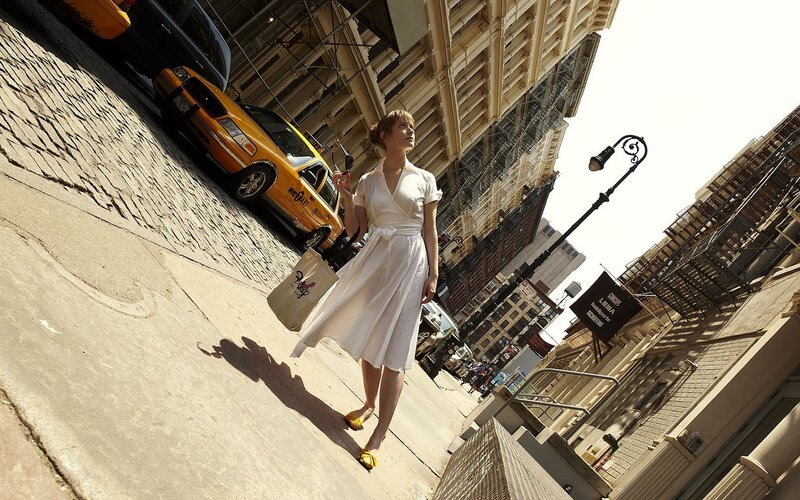 Woman in white dress on city street