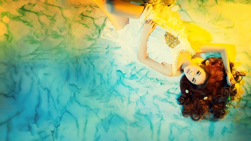 woman in white dress on colorful floor