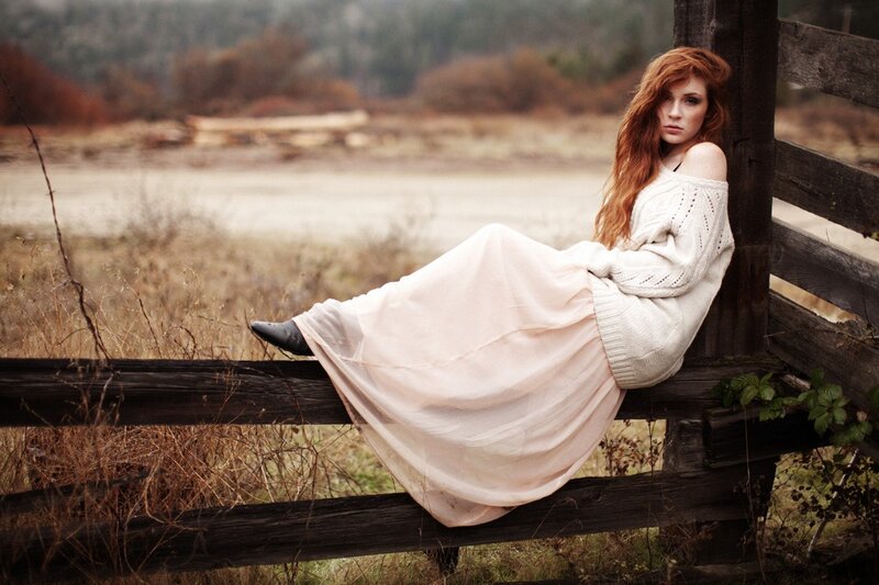Woman in white dress on fence
