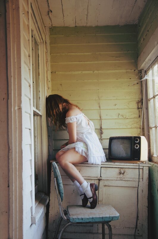 woman in white dress on porch