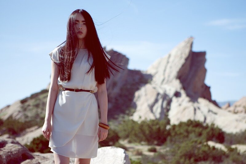 Woman in white dress on rocky hill
