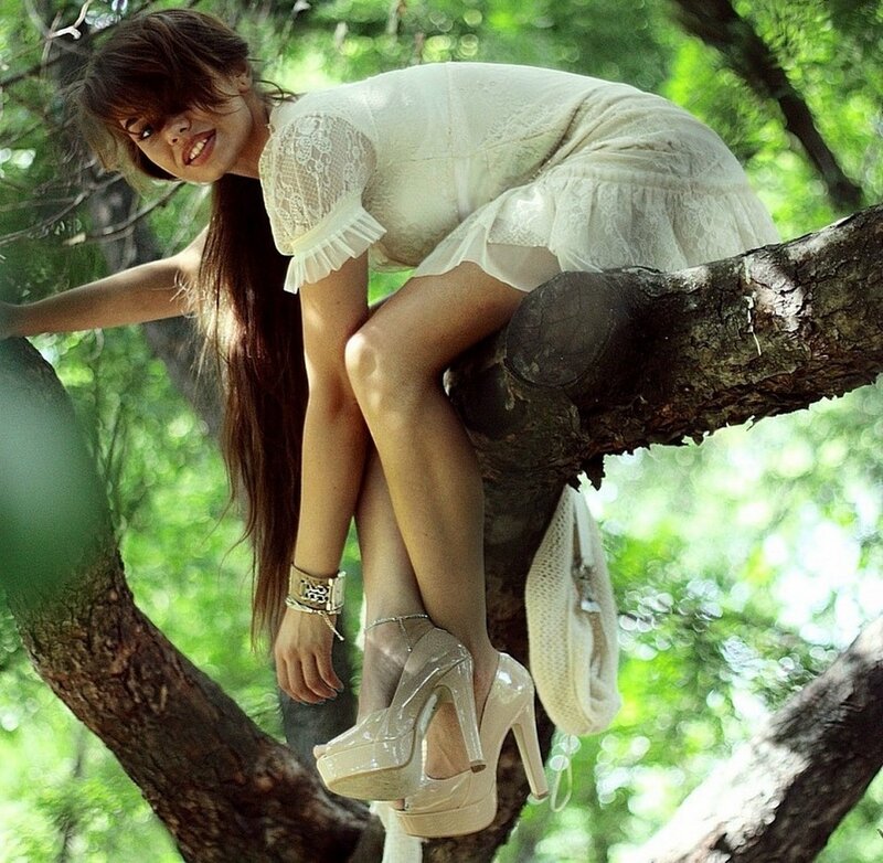woman in white dress on tree