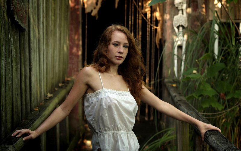 woman in white dress on wooden bridge