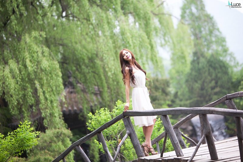 woman in white dress on wooden bridge