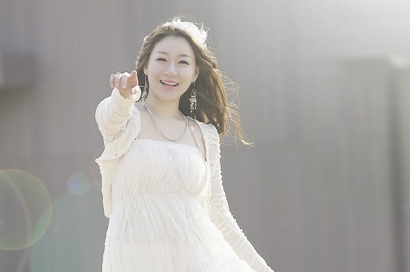 woman in white dress pointing