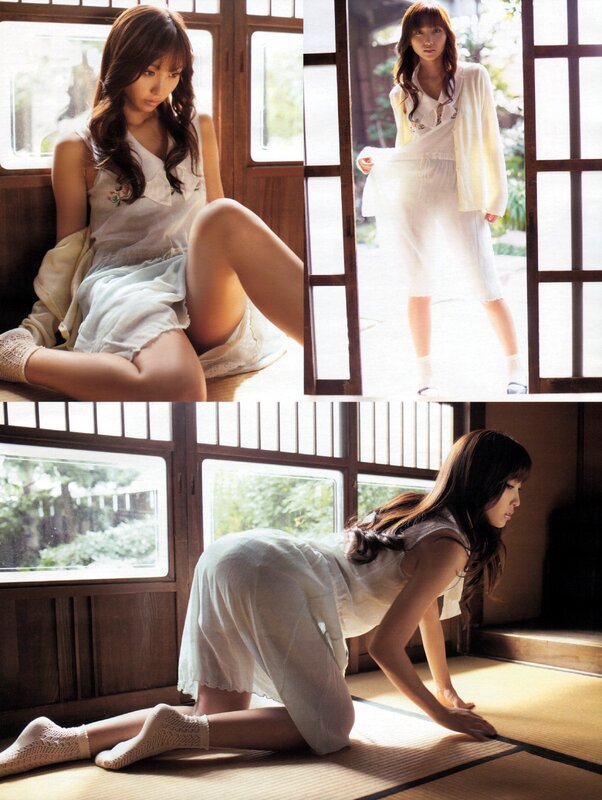 woman in white dress poses on tatami