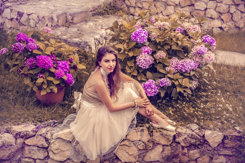 Woman in White Dress — Purple, Serene, Afternoon, Photograph, Flowers, Stone Wall