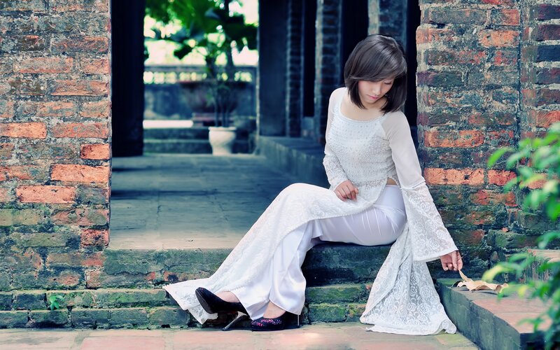 Woman in White Dress — Serene, Afternoon, Photograph, Brick Wall