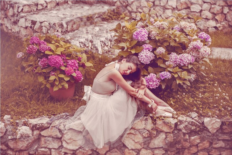 Woman in White Dress — Serene, Afternoon, Photograph, Flowers, Stone Wall, Pots