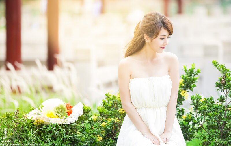 Woman in White Dress — Serene, Afternoon, Photograph, Hat, Flowers, Bushes