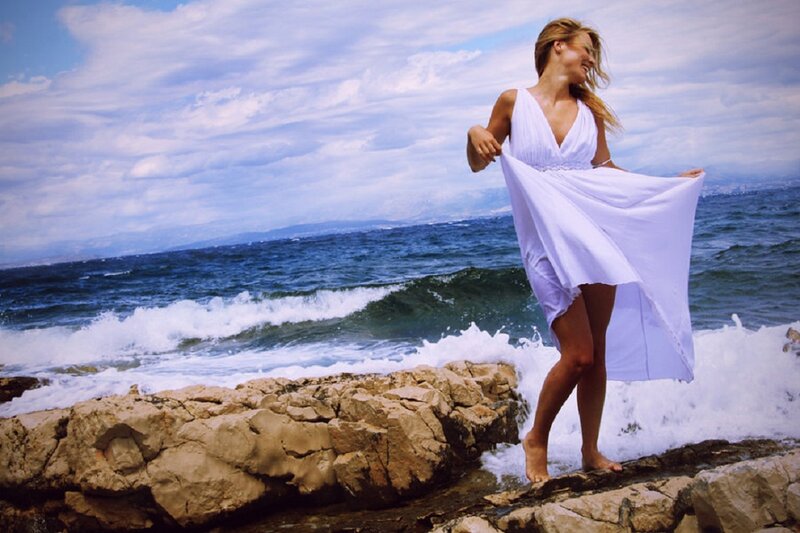 Woman in White Dress — Serene, Afternoon, Photograph, Ocean, Rocks, Sky