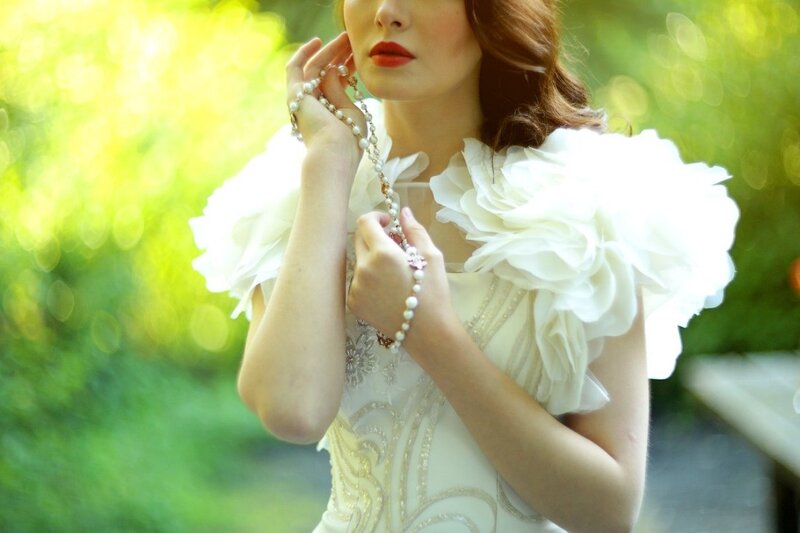 Woman in White Dress — Serene, Afternoon, Photograph, Pearl Necklace, White Flowers