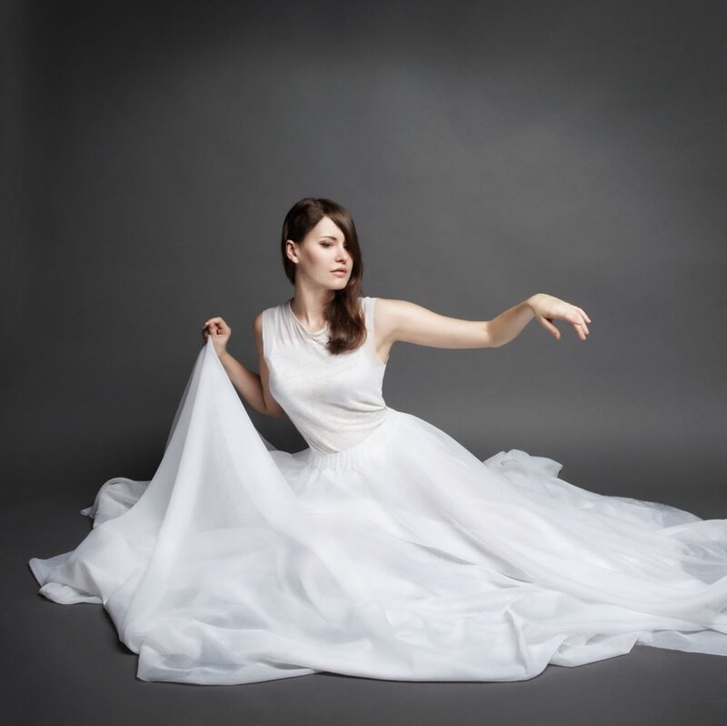 Woman in White Dress — Serene, Photograph, Studio Background, Floor