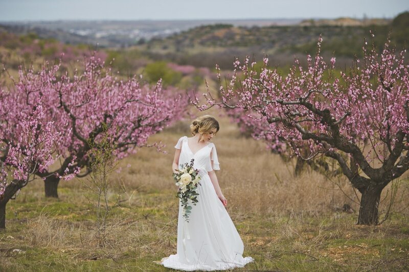 Woman in White Dress — Serene, Spring, Photograph, Flower Bouquet, Blossoming Trees