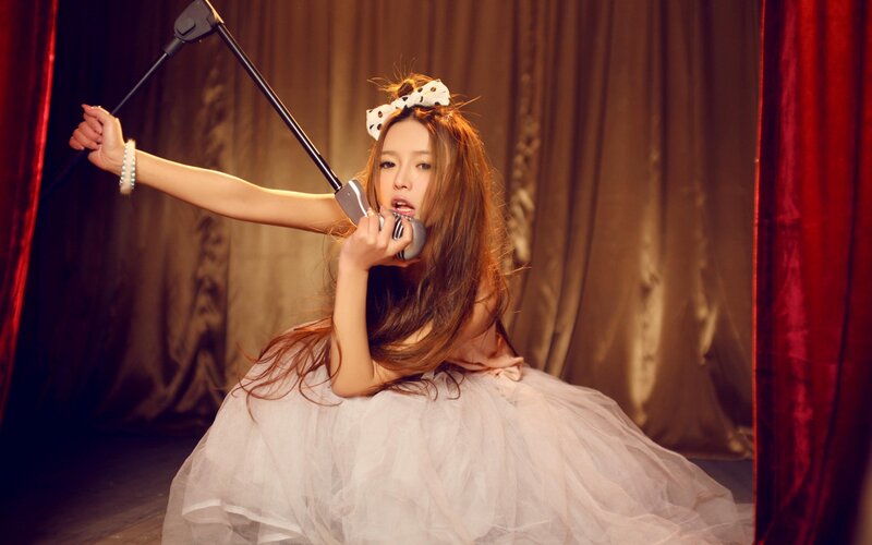 woman in white dress singing